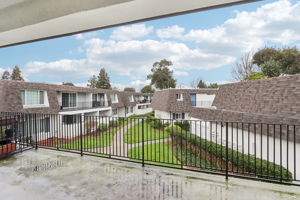 A view of a residential area with houses and a wet ground.