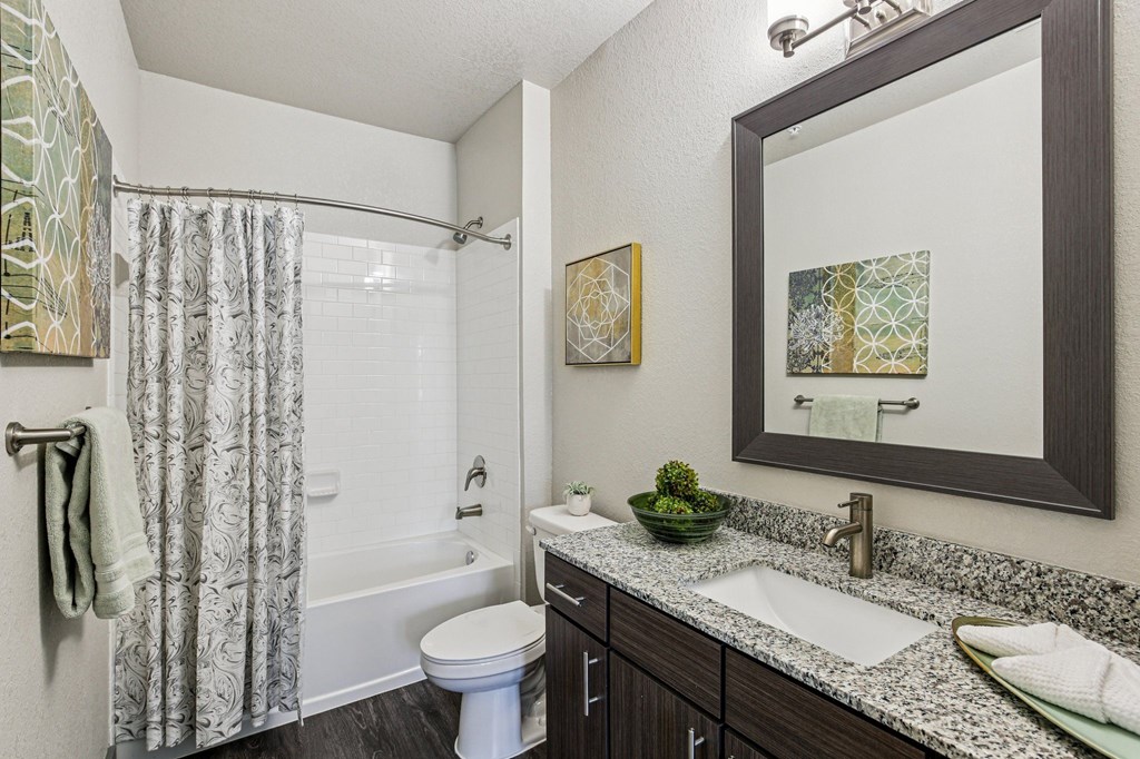 Bathroom with tub and shower head at Lotus at Starkey Ranch in Odessa, Florida.