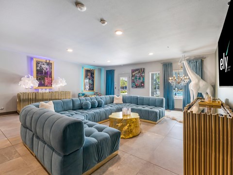 A living room with a blue couch and a white sculpture.