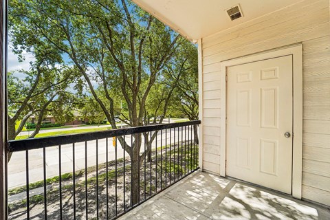A white door is on the right side of a balcony.