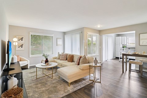 A living room with a white couch and a coffee table.