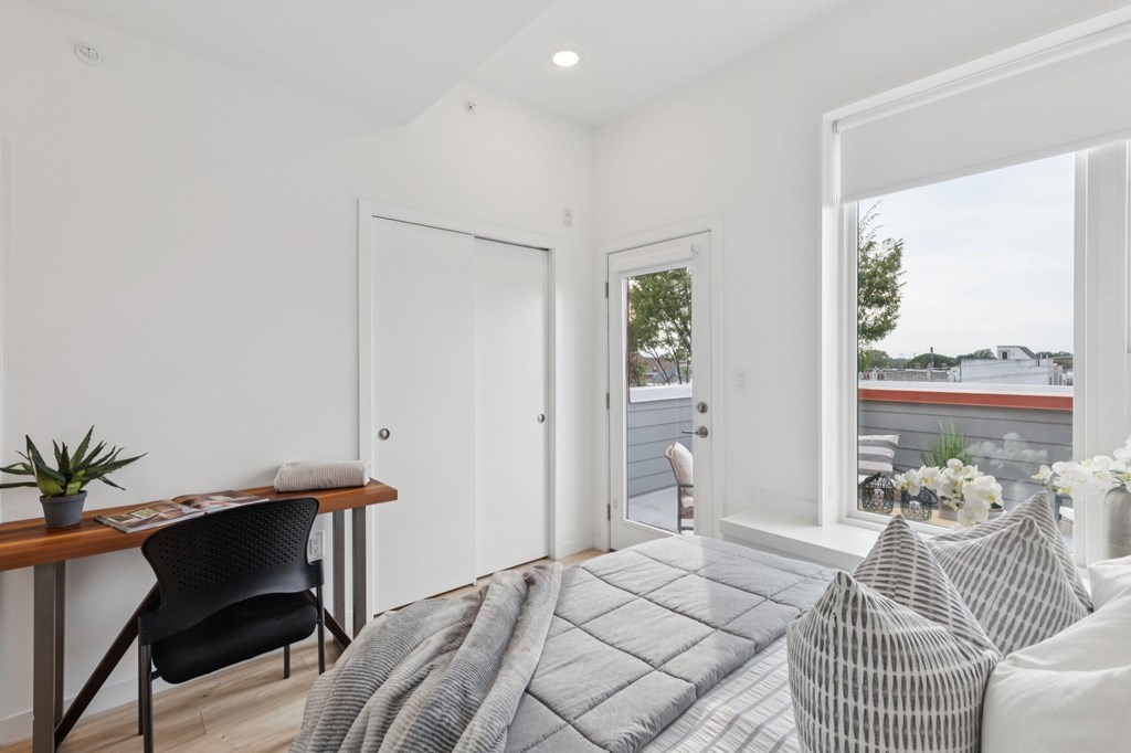 A modern living room with a grey sofa and a wooden table.