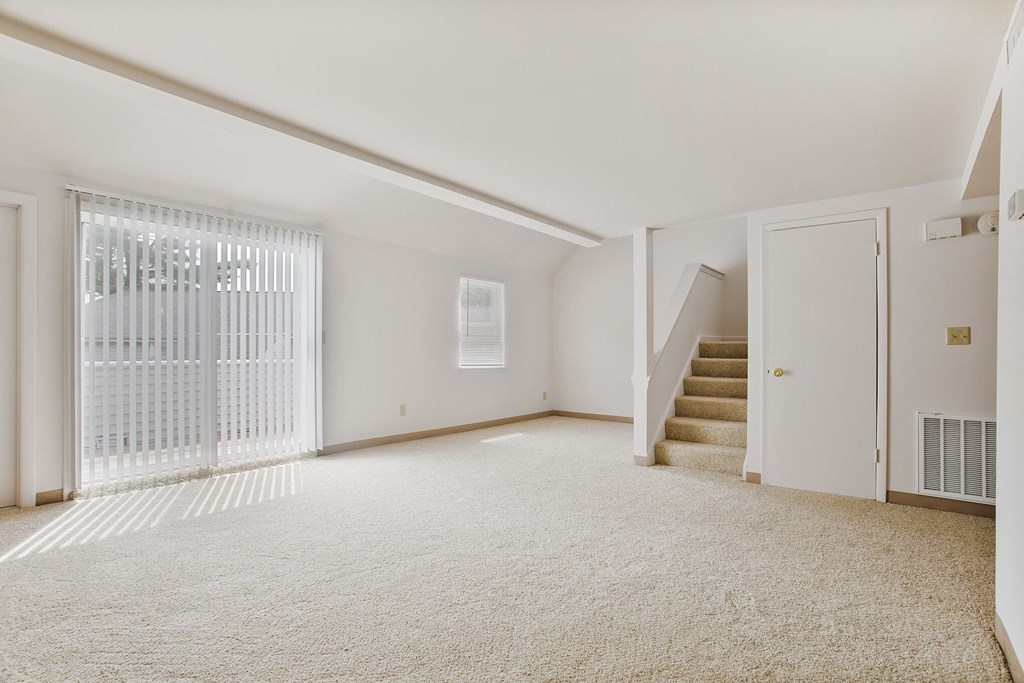 renovated living room with carpet and stairs