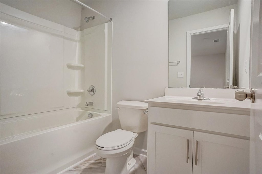 a bathroom with a toilet sink and bathtub