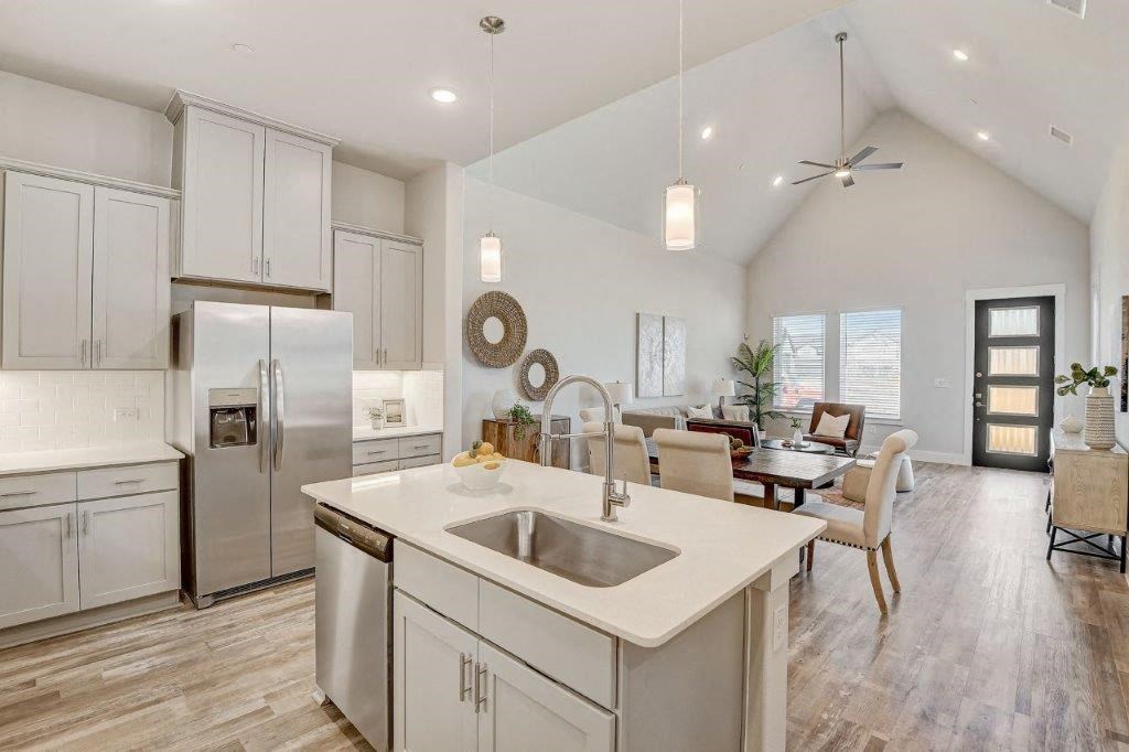 a white kitchen with a sink and a table