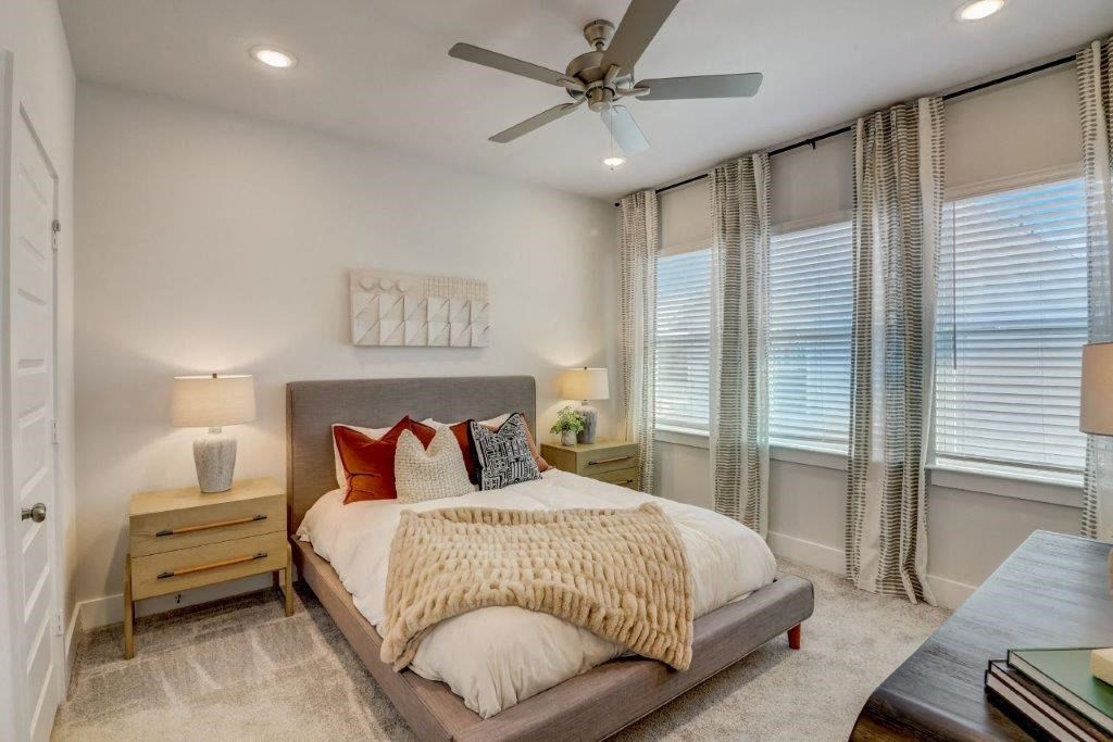 a bedroom with a bed and a ceiling fan
