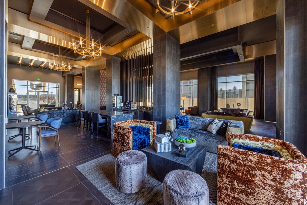 the lobby of a hotel with couches and tables