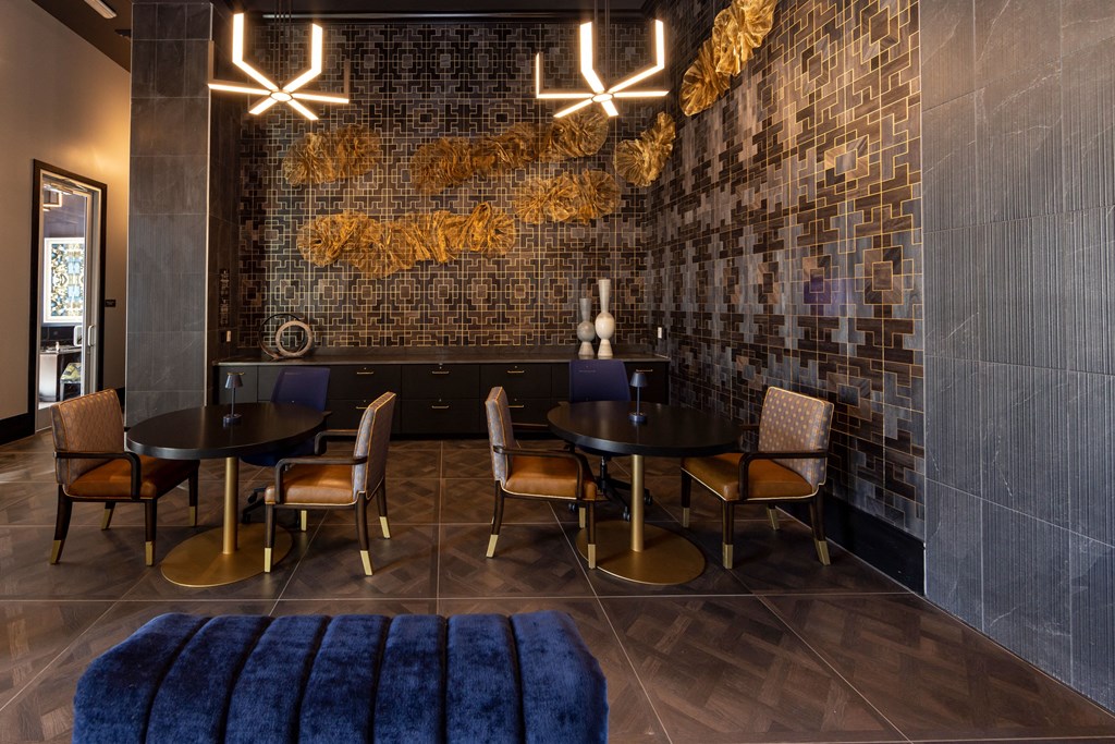 a dining room with tables and chairs and a brick wall