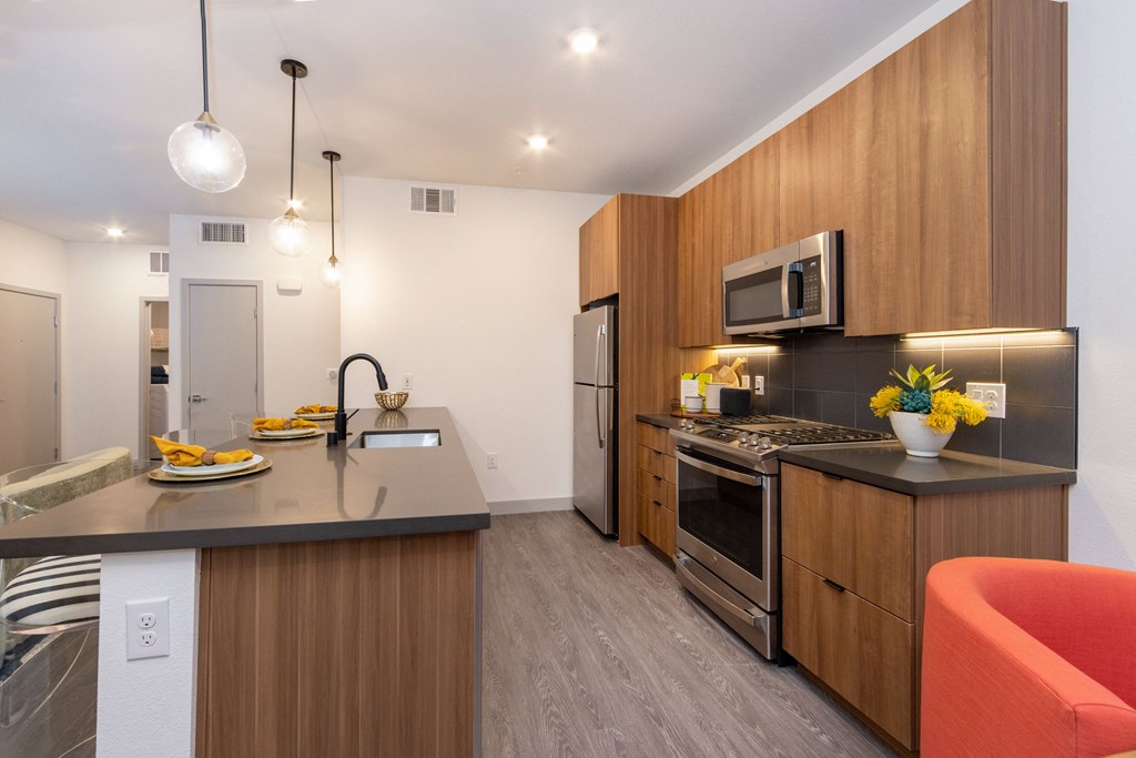 a kitchen with wooden cabinets and stainless steel appliances