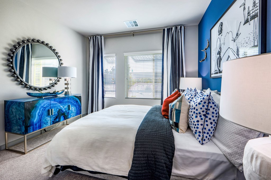 a bedroom with blue and white walls and a bed with pillows
