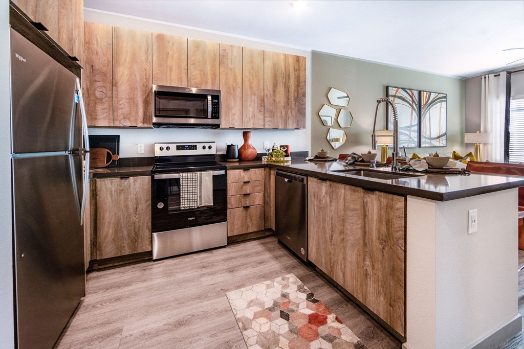 a kitchen with stainless steel appliances and wooden cabinets