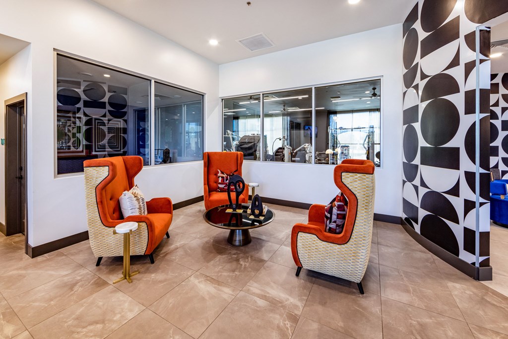 the lobby of a building with chairs and a coffee table