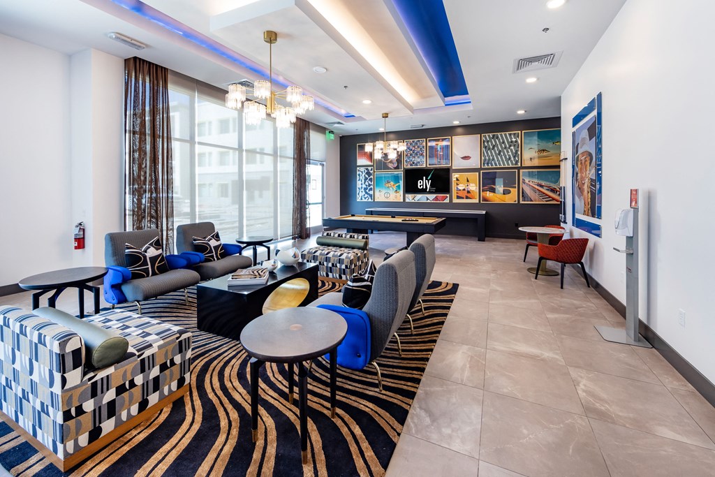 a lobby with couches tables and chairs and a large window