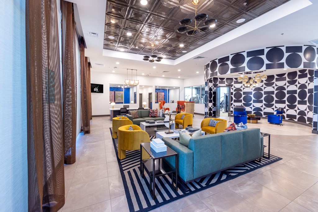 a lobby with couches and chairs and a large wall with polka dots