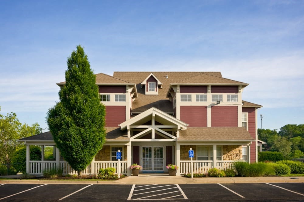 a large house with a tree in front of it