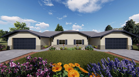 A modern house with a large front yard and colorful flowers.