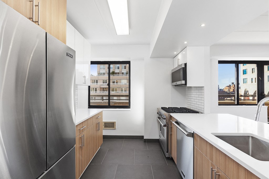 a kitchen with stainless steel appliances and a large window