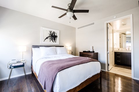 a bedroom with a bed and a ceiling fan