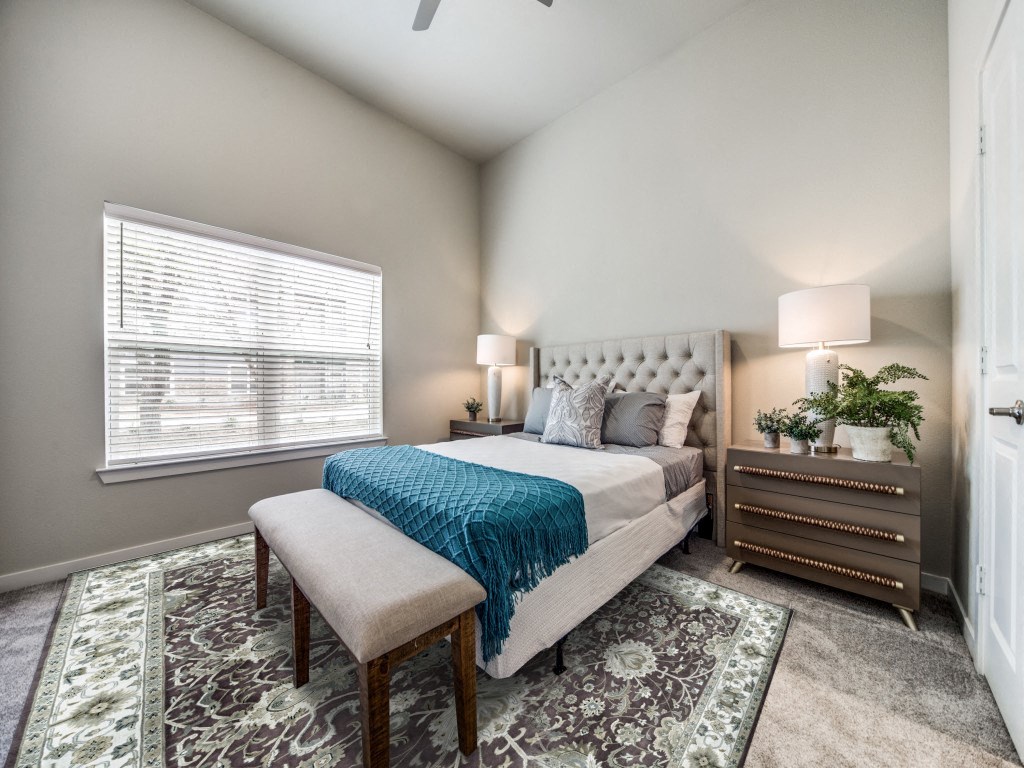 One Bedroom Senior Apartments in Boerne, TX | Boerne LIVIN | An Interior Shot of the Bedroom, Featuring Plush Carpeting, Large Windows, and High Ceilings