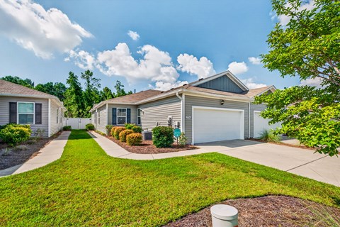 A residential house with a garage and a driveway.