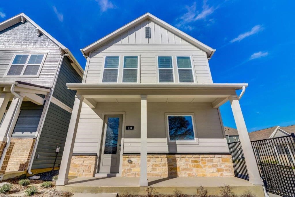 a white and gray house with a blue sky behind it