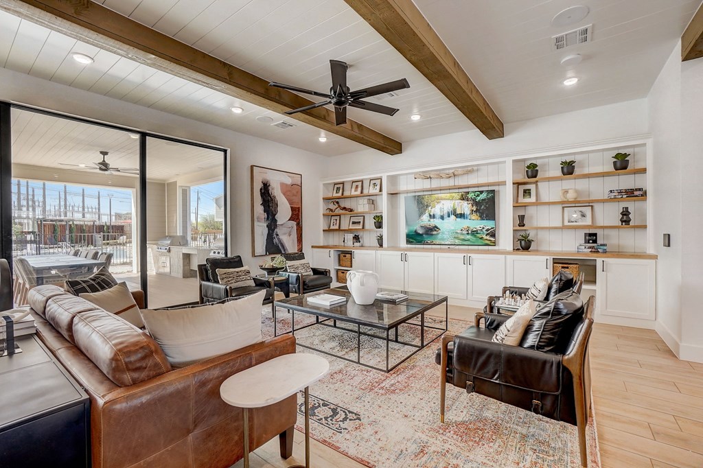 a living room with furniture and a ceiling fan