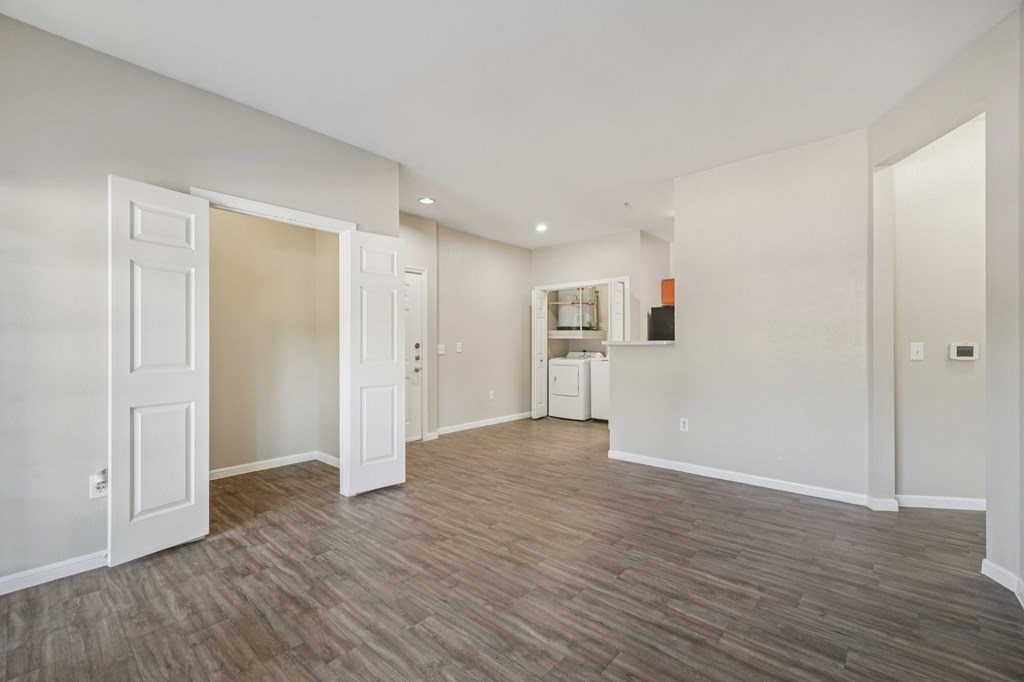 A room with a wood floor and white walls.