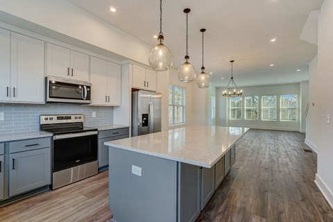 a kitchen with white cabinets and a large counter top