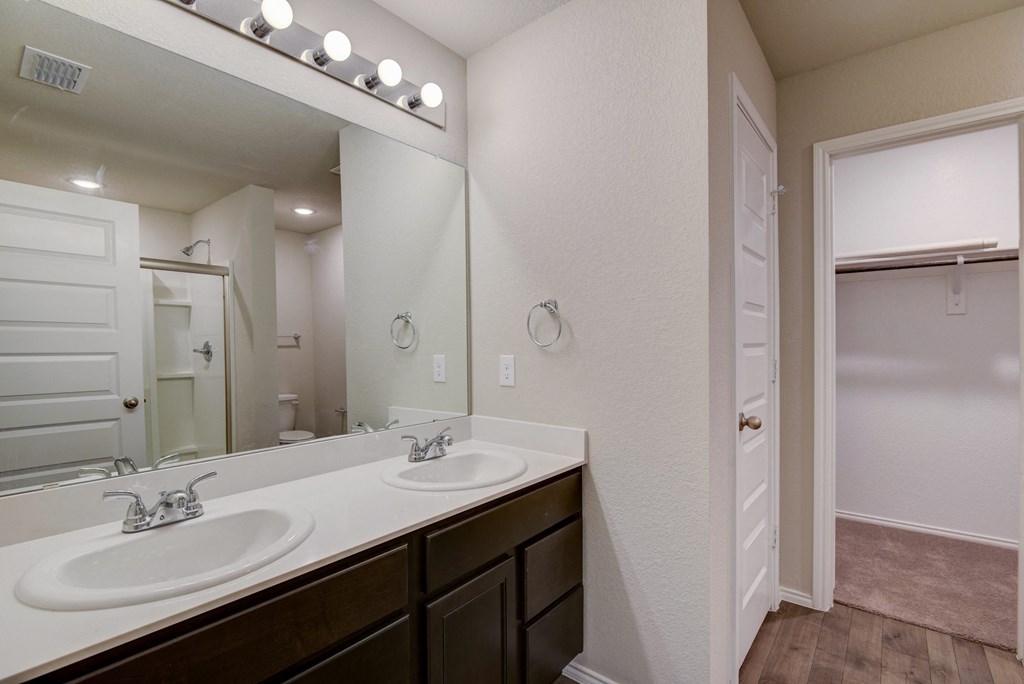 a bathroom with two sinks and a large mirror