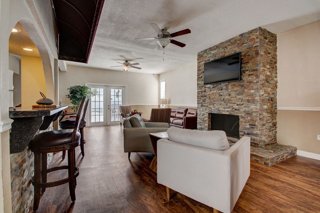 Derby Park Apartments in Daytona Beach, FL photo of the clubhouse with seating and a fireplace