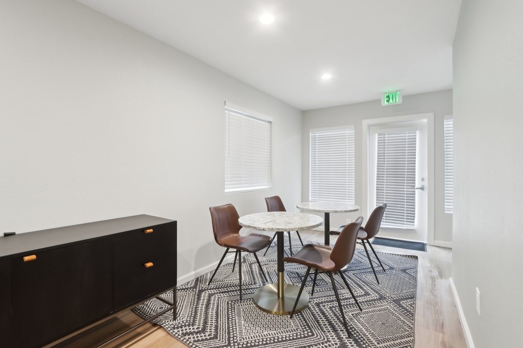 A conference room with a table and chairs.