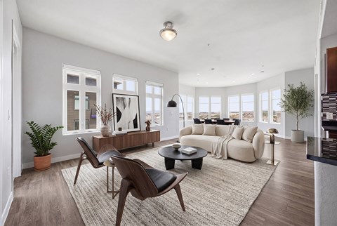 A living room with a white sofa and a black coffee table.