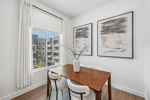 Sunlit dining area with large windows in a modern Prosper 150 apartment in Las Vegas