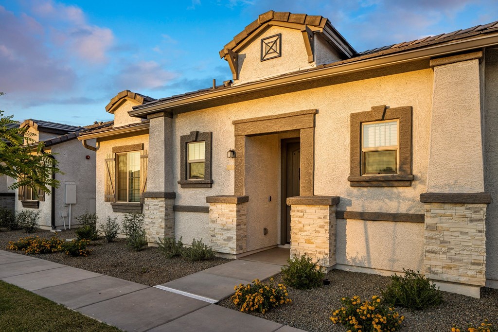 A house with a brown door and windows is shown.