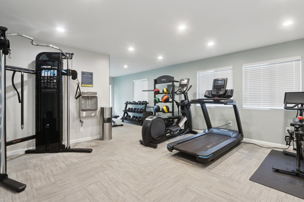 2-Bedroom Apartments In Fremont, CA - Brookvale Chateau - Fitness Center Surrounded By Windows Equipped With Cardio And Weight Machines, A Water Station, And Weights