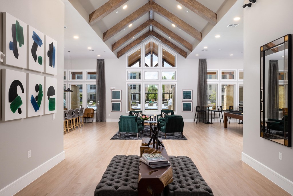 a large living room with high ceilings and windows