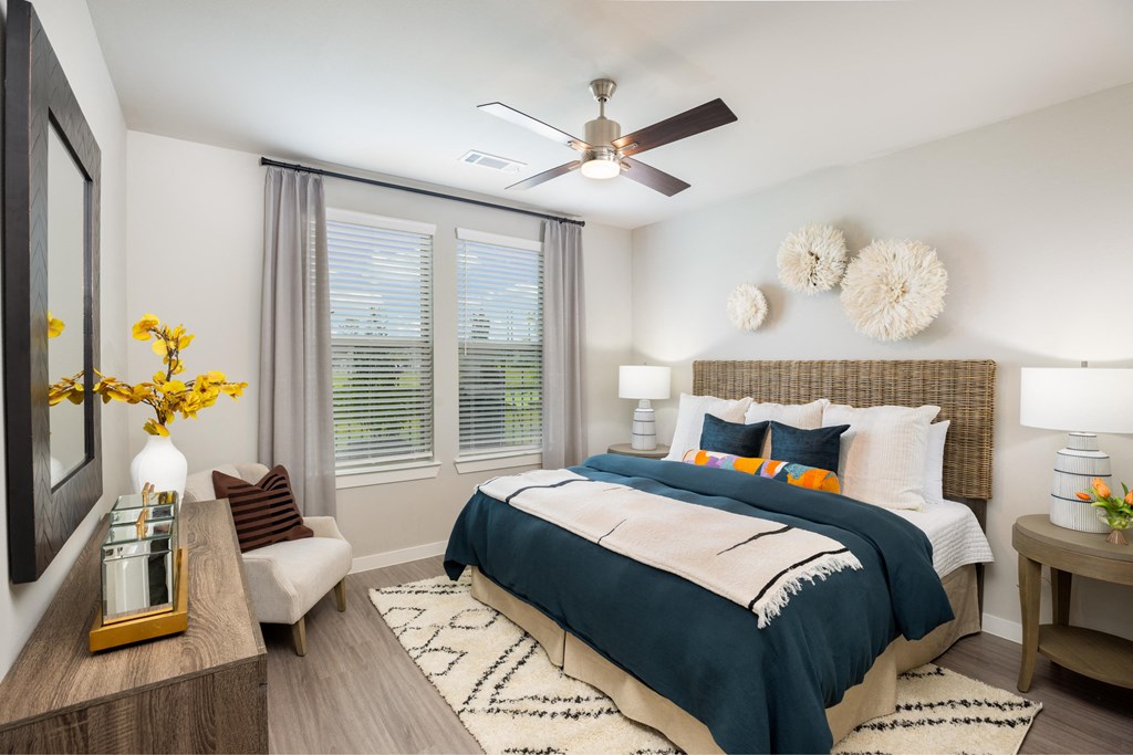 a bedroom with a large bed and a ceiling fan