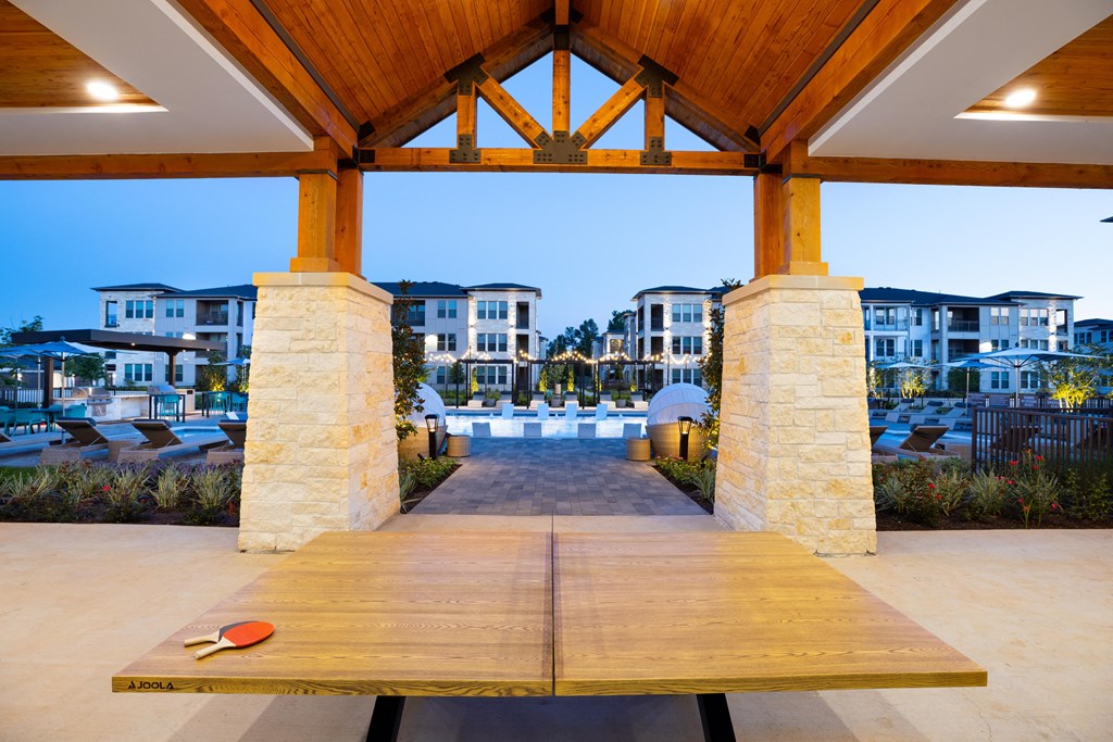 a wooden table with a boardwalk in front of a row of houses