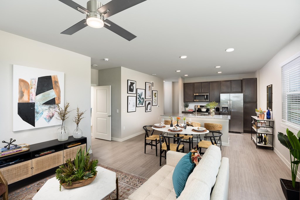 an open living room and kitchen with a dining room table