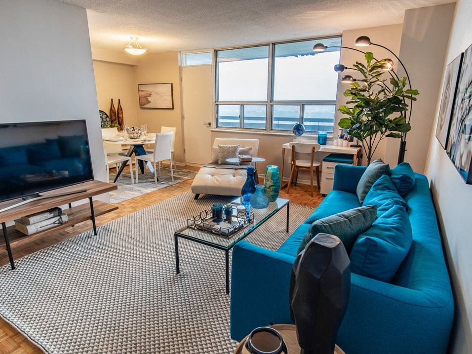 a living room with a blue couch and a television