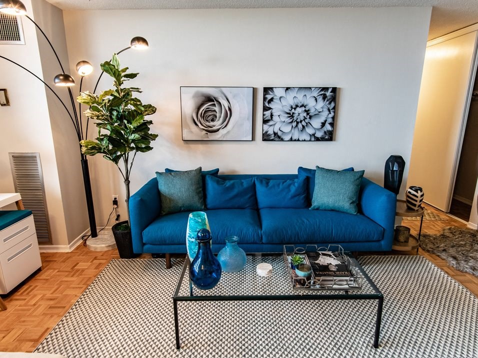 a living room with a blue couch and a coffee table