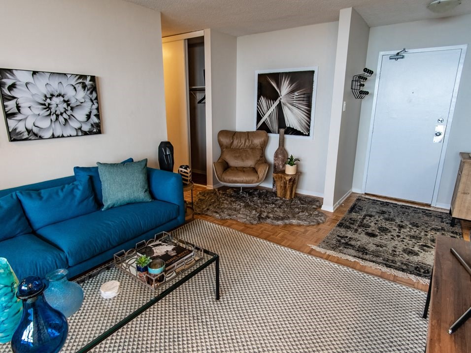 a living room with a blue couch and a door