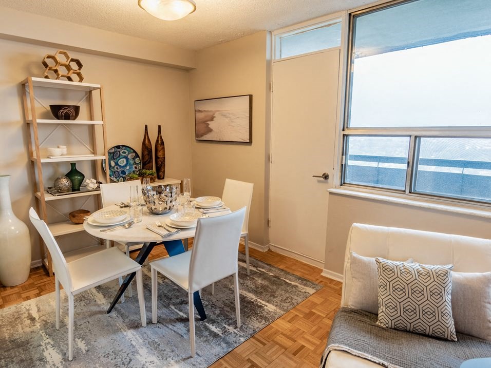 a dining room with a table and chairs and a window