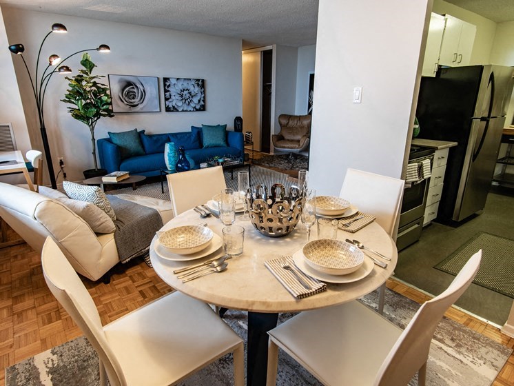 a dining room and living room with a table and chairs