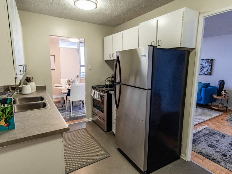 a kitchen with a refrigerator and a sink