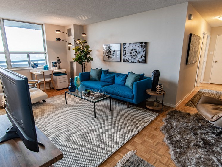 a living room with a blue couch and a tv