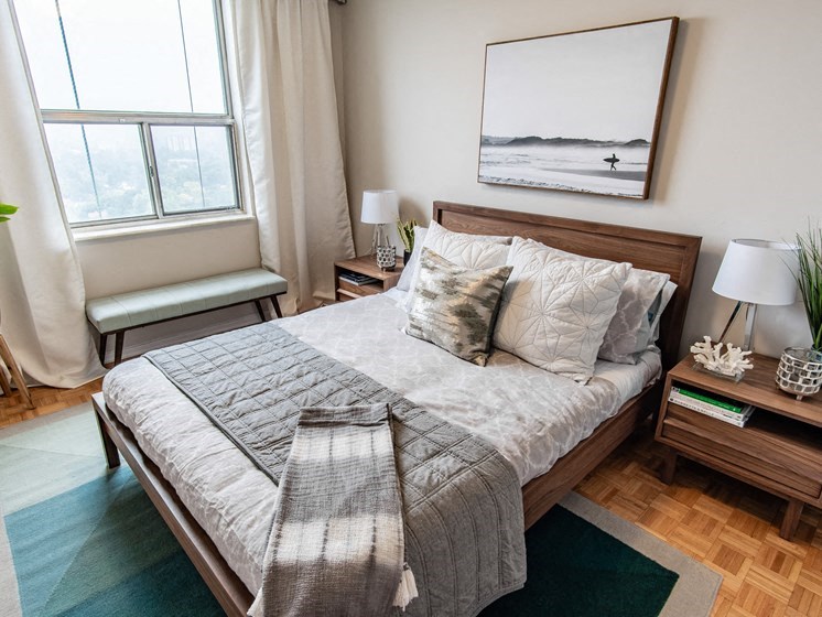 a bedroom with a bed and a window