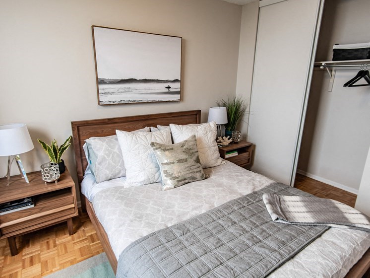 a bedroom with a bed and a picture of the beach