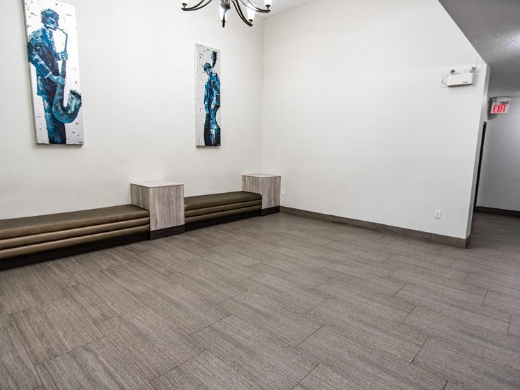 a room with two benches and paintings on the walls