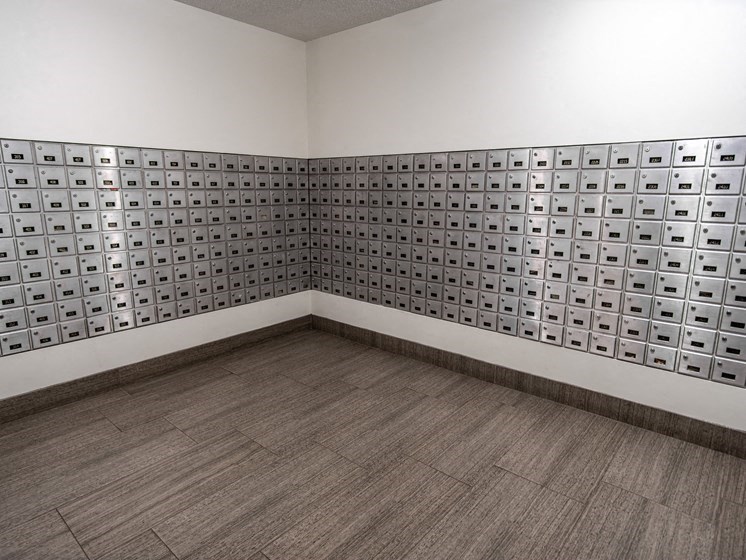 an empty room with a wood floor and a wall with squares